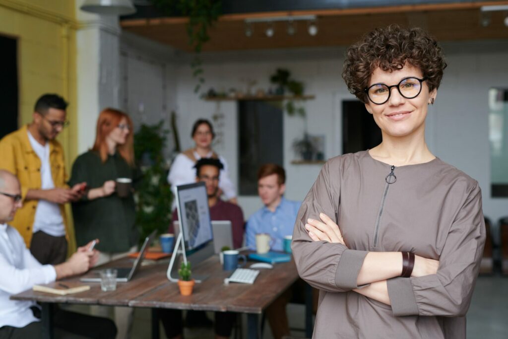 Woman standing in front of team of workers